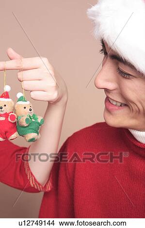 Picture - Man having a stuffed toy of bear. Fotosearch