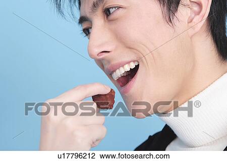 Man trying to eat chocolate View Large Photo Image Stock Image - Man trying to eat chocolate. Fotosearch