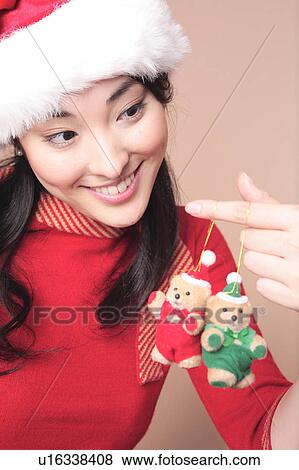 Stock Photo - Woman having a stuffed toy of bear. Fotosearch