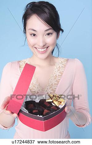 Stock Photo - Woman having heart shaped box. Fotosearch