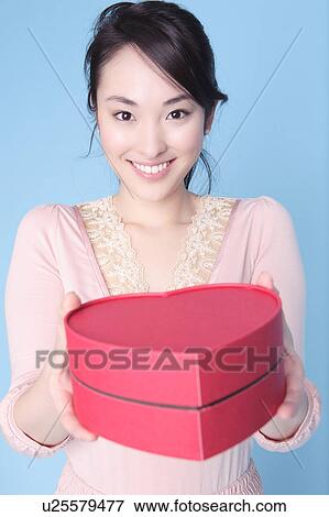 Stock Photo - Woman having heart shaped box. Fotosearch