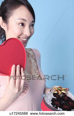 Stock Photograph - Woman having heart shaped box. Fotosearch