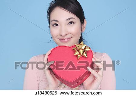 Stock Photography - Woman having heart shaped box. Fotosearch