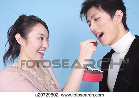 Woman let a man eat chocolate View Large Photo Image Stock Image - Woman let a man eat chocolate. Fotosearch
