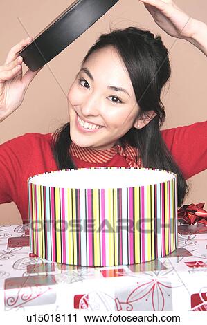Woman opening a box View Large Photo Image Stock Image - Woman opening a box. Fotosearch