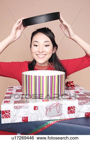 Woman opening a box View Large Photo Image Stock Photograph - Woman opening a box. Fotosearch