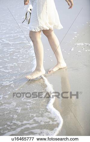 Stock Photo - Foot of Japanese woman on the beach. Fotosearch