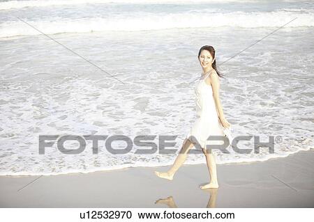 Japanese woman walking barefoot on a beach View Large Photo Image Stock Image - Japanese woman walking barefoot on a beach. Fotosearch