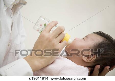 Baby drinking milk View Large Photo Image Picture - Baby drinking milk. Fotosearch