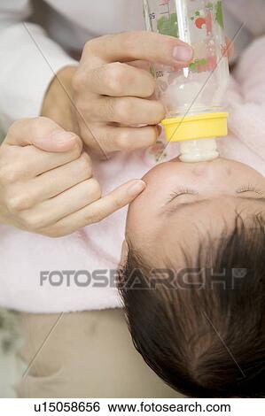 Stock Photograph - Baby drinking milk. Fotosearch