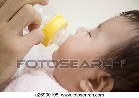 Stock Photography - Baby drinking milk. Fotosearch