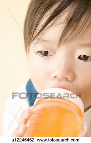 Stock Image - Baby drinking tea. Fotosearch