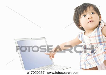 Stock Photo - Baby pointing to PC. Fotosearch