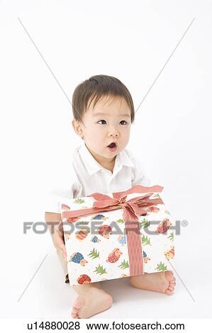 Stock Photo - Baby with a present. Fotosearch