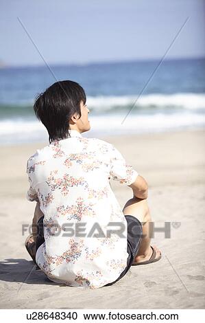 Stock Image - Back figure of Japanese young man. Fotosearch