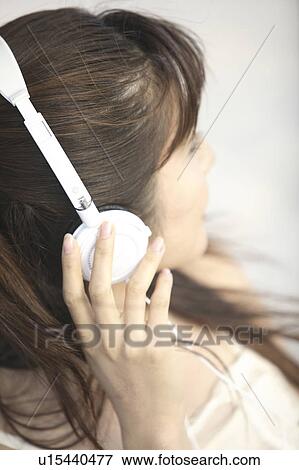 Japanese woman listening to music View Large Photo Image Stock Photo - Japanese woman listening to music. Fotosearch