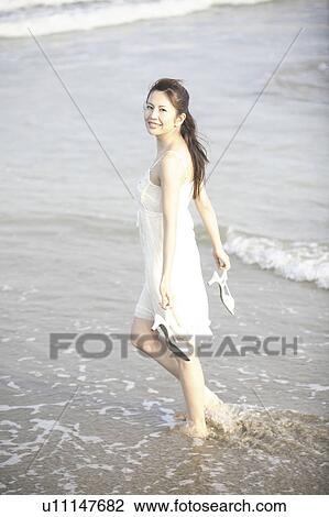 Stock Image - Japanese woman on the beach. Fotosearch