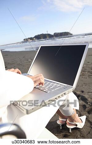 Office lady operating a PC on a beach View Large Photo Image Stock Image - Office lady operating a PC on a beach. Fotosearch