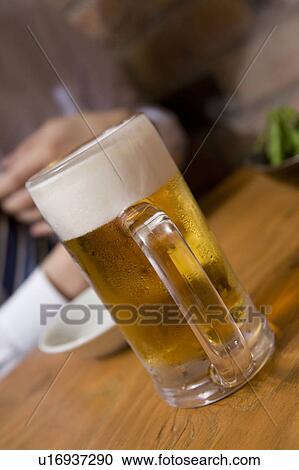 Stock Image - Beer mug on a table. Fotosearch