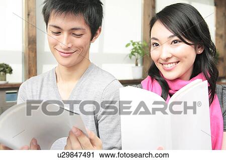Stock Image - Japanese couple reading books. Fotosearch