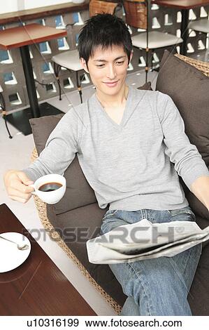Stock Photo - Japanese man reading a newspaper. Fotosearch