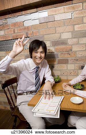 Picture - Office worker ordering food at bar. Fotosearch