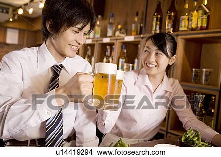 Office workers enjoy drinking a beer View Large Photo Image Picture - Office workers enjoy drinking a beer. Fotosearch