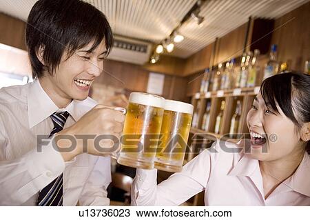Stock Image - Office workers enjoy drinking a beer. Fotosearch
