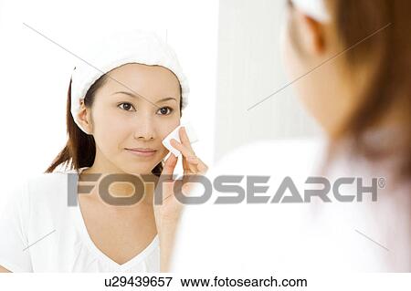 Stock Photo - Japanese woman doing skin care. Fotosearch
