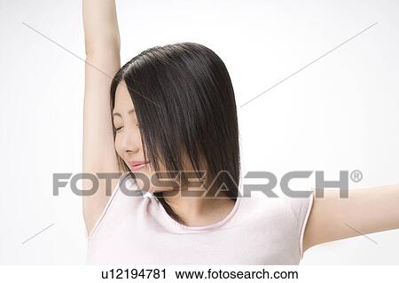 Stock Image - Japanese woman stretching. Fotosearch