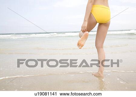 Stock Image - Back figure of Japanese woman in swimsuit. Fotosearch