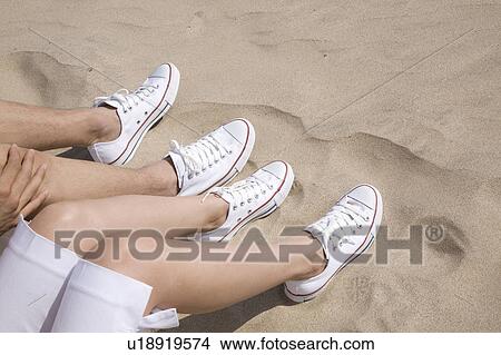 Picture - Foot of couple on a beach. Fotosearch