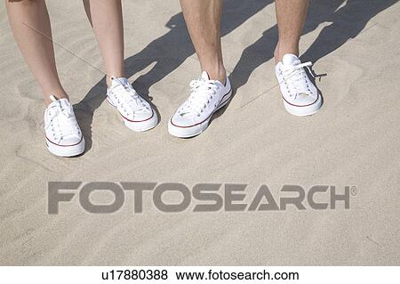 Stock Photo - Foot of couple on a beach. Fotosearch