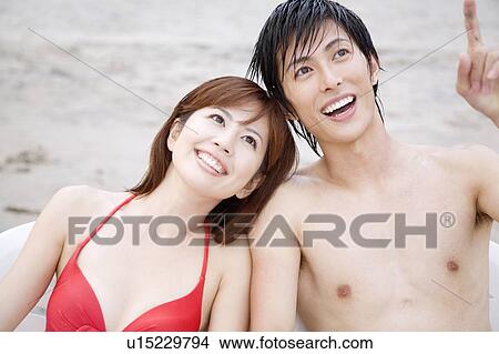 Picture - Japanese couple in swimsuit. Fotosearch