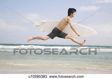 Stock Image - Japanese man jumping. Fotosearch