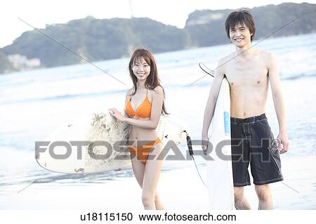 Stock Image - Japanese surfer in Enoshima beach. Fotosearch