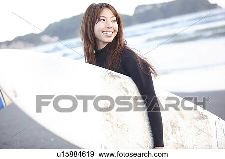 Stock Photo - Japanese surfer in Enoshima beach. Fotosearch