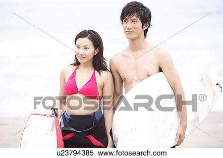 Stock Photography - Young Japanese surfer couple. Fotosearch