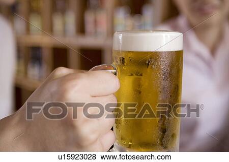 Hand having a beer mug View Large Photo Image Stock Photo - Hand having a beer mug. Fotosearch