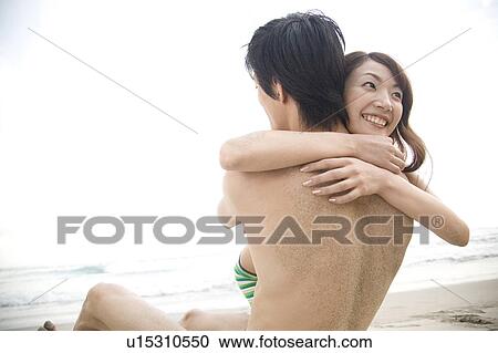 Stock Image - Japanese couple hugging each other. Fotosearch