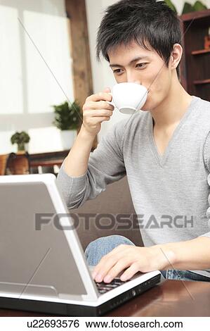 Japanese man operating a PC View Large Photo Image Stock Photograph - Japanese man operating a PC. Fotosearch