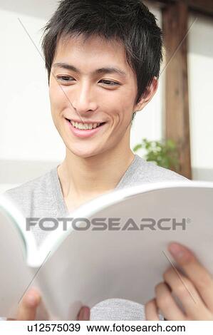 Stock Photo - Japanese man reading a book. Fotosearch