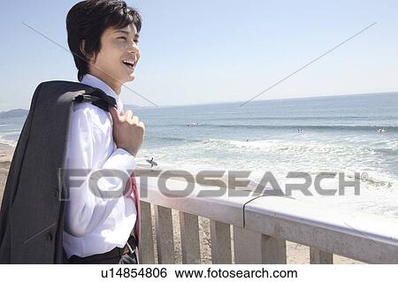 Japanese office worker looking at ocean View Large Photo Image Stock Photograph - Japanese office worker looking at ocean. Fotosearch
