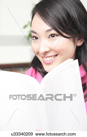 Stock Photo - Japanese woman reading a book. Fotosearch