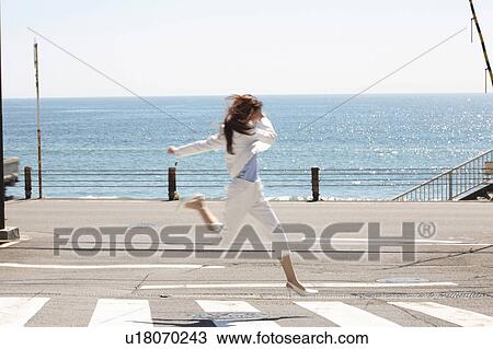 Stock Image - Jumpping Japanese office lady. Fotosearch