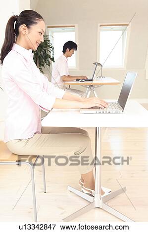 Office lady operating a PC View Large Photo Image Stock Photo - Office lady operating a PC. Fotosearch