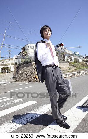 Stock Photo - Office worker crossing street. Fotosearch