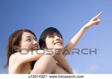 Stock Image - Smiling Japanese couple. Fotosearch