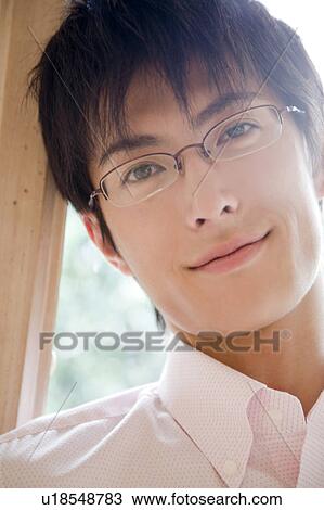 Stock Image - Smiling man wearing glasses. Fotosearch