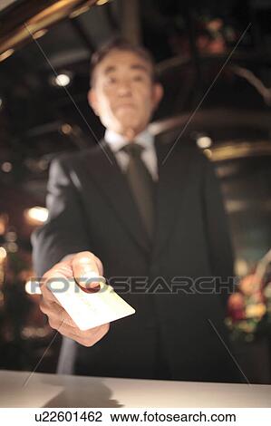 Japanese executive checking by credit card View Large Photo Image Stock Image - Japanese executive checking by credit card. Fotosearch